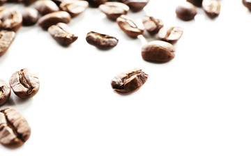 Coffee beans on white table, close-up