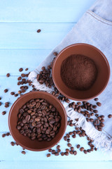 Two bowls of ground coffee and coffee beans