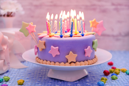 Delicious birthday cake on table on light background