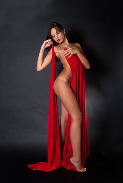 Fototapeta Nude body covered with a reb fabric