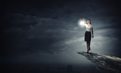 Businesswoman with lantern