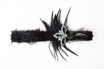 Black feather headband on white