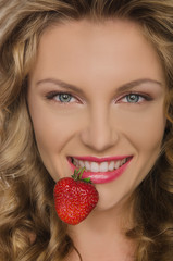 Beautiful woman with strawberry teeth