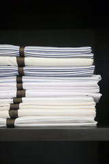 Fabric stacked in black storage