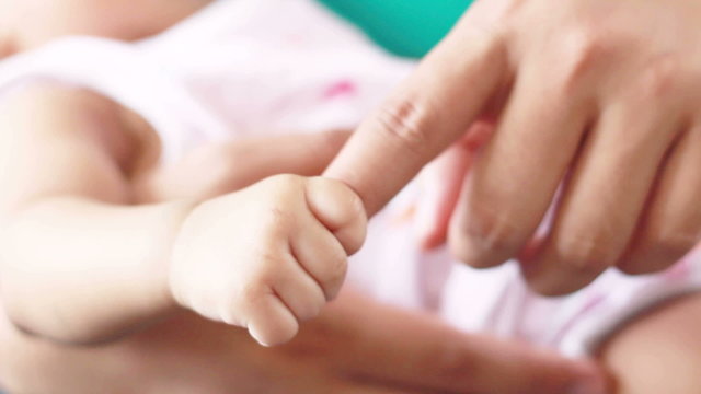 HD Footage of baby holding mother finger, close up