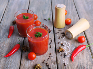 Tomato juice in glasses and fresh vegetables