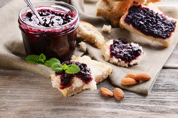 Delicious black currant jam on table close-up