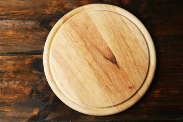 Empty cutting board on wooden background