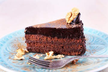 Delicious chocolate cake on plate on bright background