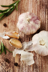 Raw garlic and spices on wooden table