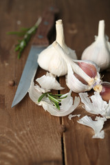 Raw garlic and spices on wooden table