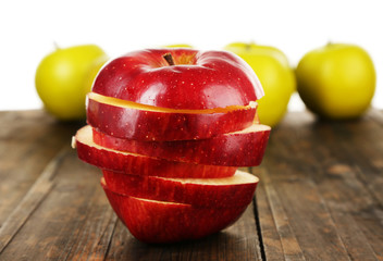Cut apple on wooden table with other apples background