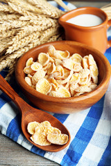 Sweet cereals in bowl and jug with milk