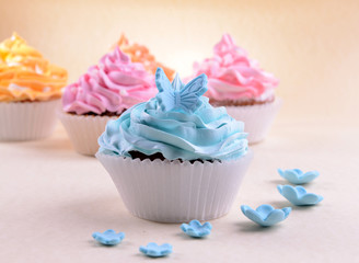 Delicious cupcakes on beige background