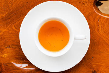 White cup of tea on wood table