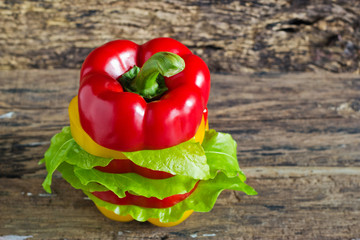 colorful sweet pepper slices decoration on wooden