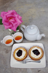 Blueberry cheese pie and white kettle with rose