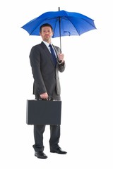 Serious businessman holding his umbrella and briefcase