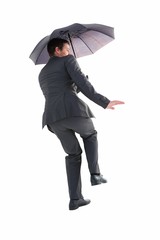 Businesswoman in suit holding umbrella