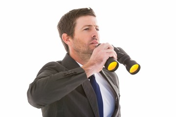 Focused handsome businessman holding binoculars