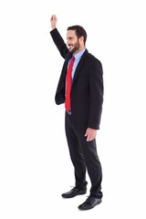 Smiling businessman standing with hand raised