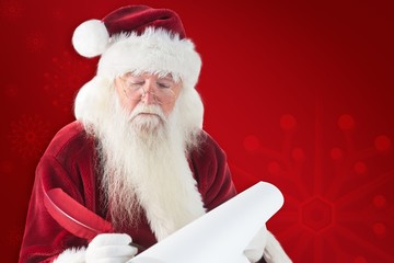 Composite image of santa writes something with a feather