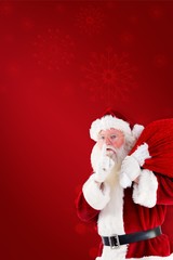 Composite image of santa claus carrying sack