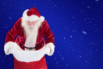 Composite image of santa looks in his bag