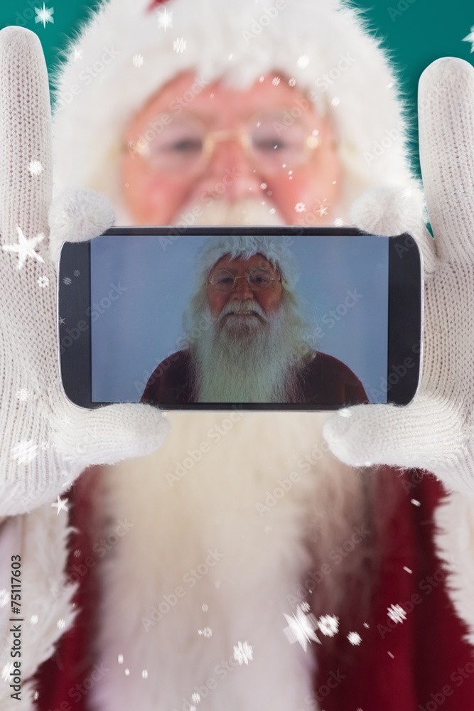Aufkleber composite image of santa records himself with a smartphone