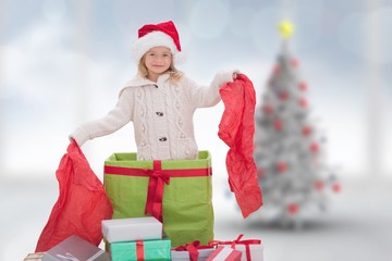 Composite image of cute girl in large gift