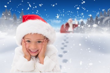 Composite image of cute little girl wearing santa hat