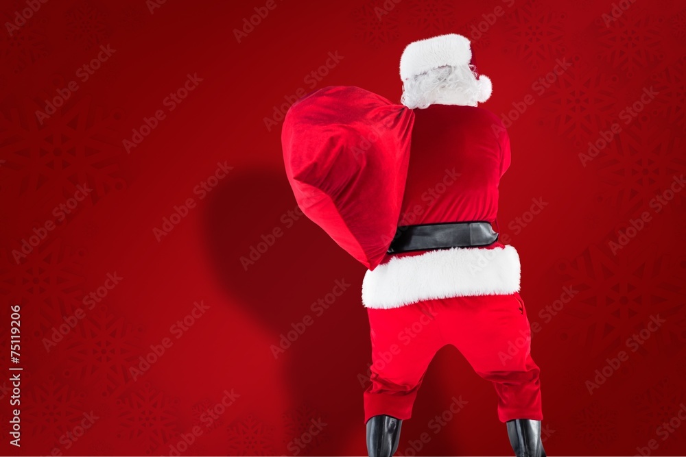 Poster composite image of rear view of santa holding a sack