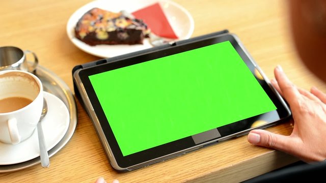 woman works on tablet green screen in cafe - coffe and cake