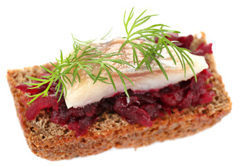 Canape herring with beets on rye toast, isolated on white