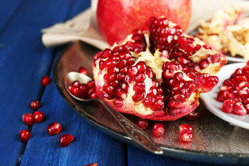 Juicy ripe pomegranates on wooden table