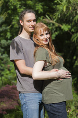 Young Couple in a park awaiting a Baby
