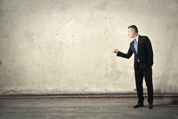 Fototapeta premium Businessman drawing something on a wall