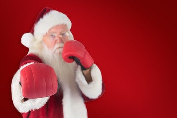 Composite image of santa claus punches with his right