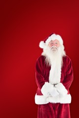 Composite image of jolly santa smiling at camera