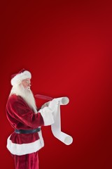 Composite image of father christmas writes a list