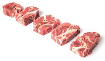 Chunk of cut frozen beef meat over white background 
