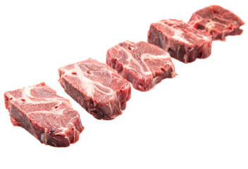 Chunk of cut frozen beef meat over white background 
