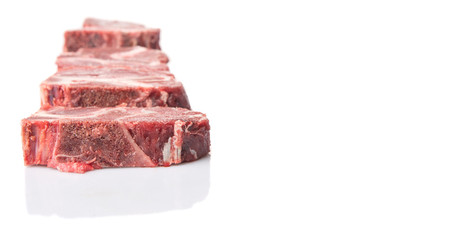 Chunk of cut frozen beef meat over white background 