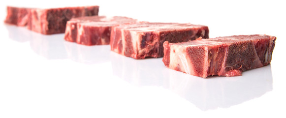 Chunk of cut frozen beef meat over white background 