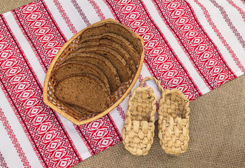 Pair of bast shoes and pieces of rye bread