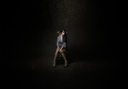 girl sitting in a dark room
