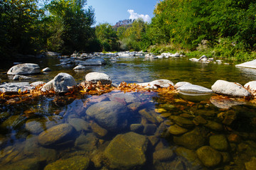 Dam from stones  on the mountain river