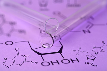 Fototapeta na wymiar Test tube and reaction formula, close-up