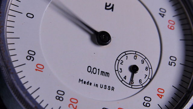 Rotating arrows on the instrument measuring the thickness