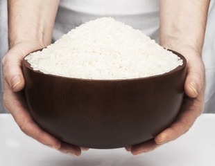 Rice in the hands on white background